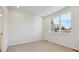 Spacious bedroom with large window and neutral carpeting at 461 Interlocken Blvd # 103, Broomfield, CO 80021