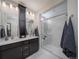 Elegant bathroom with double vanity, large shower, and modern finishes at 5150 N Quemoy Ct, Aurora, CO 80019