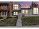 Two-story townhome with brick exterior and a landscaped yard at 1100 S Waco St # G, Aurora, CO 80017