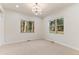 Spacious bedroom with large windows and a chandelier at 4381 Cheyenne Dr, Larkspur, CO 80118
