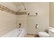 Bathroom with tub, shower, and tile details at 4381 Cheyenne Dr, Larkspur, CO 80118