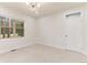 Well-lit bedroom with window and door at 4381 Cheyenne Dr, Larkspur, CO 80118