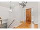 Bright and spacious entryway with hardwood floors and elegant chandelier at 4381 Cheyenne Dr, Larkspur, CO 80118