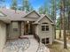 Inviting ranch home with stone pathway, and mature trees at 4381 Cheyenne Dr, Larkspur, CO 80118