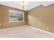 Simple bedroom with large window and chandelier at 4381 Cheyenne Dr, Larkspur, CO 80118