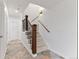 Elegant staircase with wooden railing and tile flooring at 4381 Cheyenne Dr, Larkspur, CO 80118