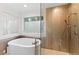 Spa-like bathroom featuring a large soaking tub and glass shower at 4381 Cheyenne Dr, Larkspur, CO 80118