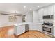 Modern kitchen with stainless steel appliances and white cabinetry at 4381 Cheyenne Dr, Larkspur, CO 80118