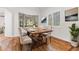 Bright dining room features hardwood floors and a wood table with six chairs at 4381 Cheyenne Dr, Larkspur, CO 80118