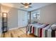 Cozy bedroom with hardwood floors, ceiling fan, and ample closet space at 2460 W Caithness Pl # 104, Denver, CO 80211