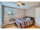 Bright bedroom with hardwood floors, ceiling fan, and window with natural light at 2460 W Caithness Pl # 104, Denver, CO 80211