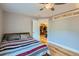 Spacious bedroom with hardwood floors and a view of the kitchen at 2460 W Caithness Pl # 104, Denver, CO 80211