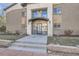 Modern building entrance with glass doors and stone steps at 2460 W Caithness Pl # 104, Denver, CO 80211