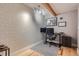 Bright home office with geometric wallpaper and built-in shelving at 2460 W Caithness Pl # 104, Denver, CO 80211