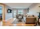 Spacious living area with hardwood floors, neutral decor, and patio access at 2460 W Caithness Pl # 104, Denver, CO 80211