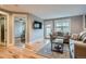 Open living area with hardwood floors, neutral walls, and access to a bedroom and patio at 2460 W Caithness Pl # 104, Denver, CO 80211