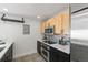 Modern kitchen with stainless steel appliances and light wood cabinets at 837 E 17Th Ave # 2K, Denver, CO 80218