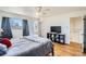 Bright bedroom with hardwood floors, private balcony access, and walk-in closet at 34 S Raleigh St, Denver, CO 80219