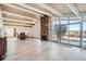 Open floor plan connecting dining and living areas with hardwood floors and stone fireplace at 34 S Raleigh St, Denver, CO 80219