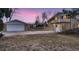 Evening view of ranch house and detached garage at 34 S Raleigh St, Denver, CO 80219