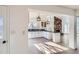 Updated kitchen featuring white cabinets, granite counters, and a breakfast bar at 34 S Raleigh St, Denver, CO 80219