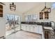 Eat-in kitchen with white cabinets, granite countertops, and sliding door access to patio at 34 S Raleigh St, Denver, CO 80219