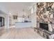 Bright kitchen features a large island, stone fireplace, and updated appliances at 34 S Raleigh St, Denver, CO 80219