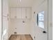 Bright laundry room with white cabinets and vinyl flooring at 34 S Raleigh St, Denver, CO 80219