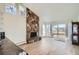 Spacious living room with stone fireplace and sliding glass doors to backyard at 34 S Raleigh St, Denver, CO 80219