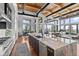 Gourmet kitchen boasts expansive island, high-end appliances, and stunning mountain views at 1082 W Meadow Rd, Evergreen, CO 80439