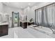 Bathroom with soaking tub, double vanity, and a walk-in shower at 1082 W Meadow Rd, Evergreen, CO 80439