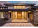 Modern home entrance with a striking wooden door and stone accents at 1082 W Meadow Rd, Evergreen, CO 80439