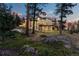 Luxury home nestled in the mountains, showcasing a stunning exterior at dusk at 1082 W Meadow Rd, Evergreen, CO 80439