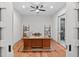 Bright home office with wood floors and built-in shelving at 1082 W Meadow Rd, Evergreen, CO 80439