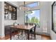 Bright dining area features a lovely wooden table and a view at 1082 W Meadow Rd, Evergreen, CO 80439