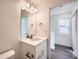 Modern bathroom with a vanity and a view of the hallway at 10291 E 62Nd Pl, Denver, CO 80238