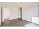 Well-lit bedroom featuring wood-look floors and an open door at 10291 E 62Nd Pl, Denver, CO 80238