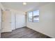 Bright bedroom with wood-look floors and sliding door closet at 10291 E 62Nd Pl, Denver, CO 80238