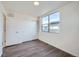 Well-lit bedroom with wood-look floors and sliding door closet at 10291 E 62Nd Pl, Denver, CO 80238