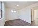 Bright bedroom with wood-look floors and an open door at 10291 E 62Nd Pl, Denver, CO 80238