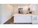 Modern kitchen with white cabinets and stainless steel appliances at 10291 E 62Nd Pl, Denver, CO 80238