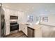 Modern kitchen with stainless steel appliances and white cabinetry at 10291 E 62Nd Pl, Denver, CO 80238