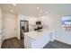 Modern kitchen with white cabinets, stainless steel appliances, and an island at 10291 E 62Nd Pl, Denver, CO 80238