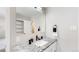 Clean bathroom with granite countertop, modern sink, and a large mirror at 3067 S Holly Pl, Denver, CO 80222