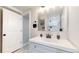 Clean basement bathroom with subway tile shower and vanity at 3067 S Holly Pl, Denver, CO 80222