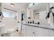 Modern bathroom with white subway tiles, granite countertop, and updated fixtures at 3067 S Holly Pl, Denver, CO 80222