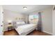 Well-lit bedroom featuring a comfortable bed and dark hardwood floors at 3067 S Holly Pl, Denver, CO 80222