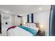 Basement bedroom with queen bed and purple throw blanket at 3067 S Holly Pl, Denver, CO 80222