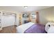 Comfortable bedroom with a large bed, en-suite bathroom, and a walk-in closet at 3067 S Holly Pl, Denver, CO 80222