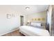 Serene bedroom with a queen-size bed, hardwood floors and wall decor at 3067 S Holly Pl, Denver, CO 80222